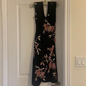 Mid length black floral dress.